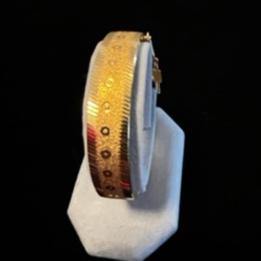 Marked West Germany 2 1/4" diameter gold tone bracelet, hinged with safety catch